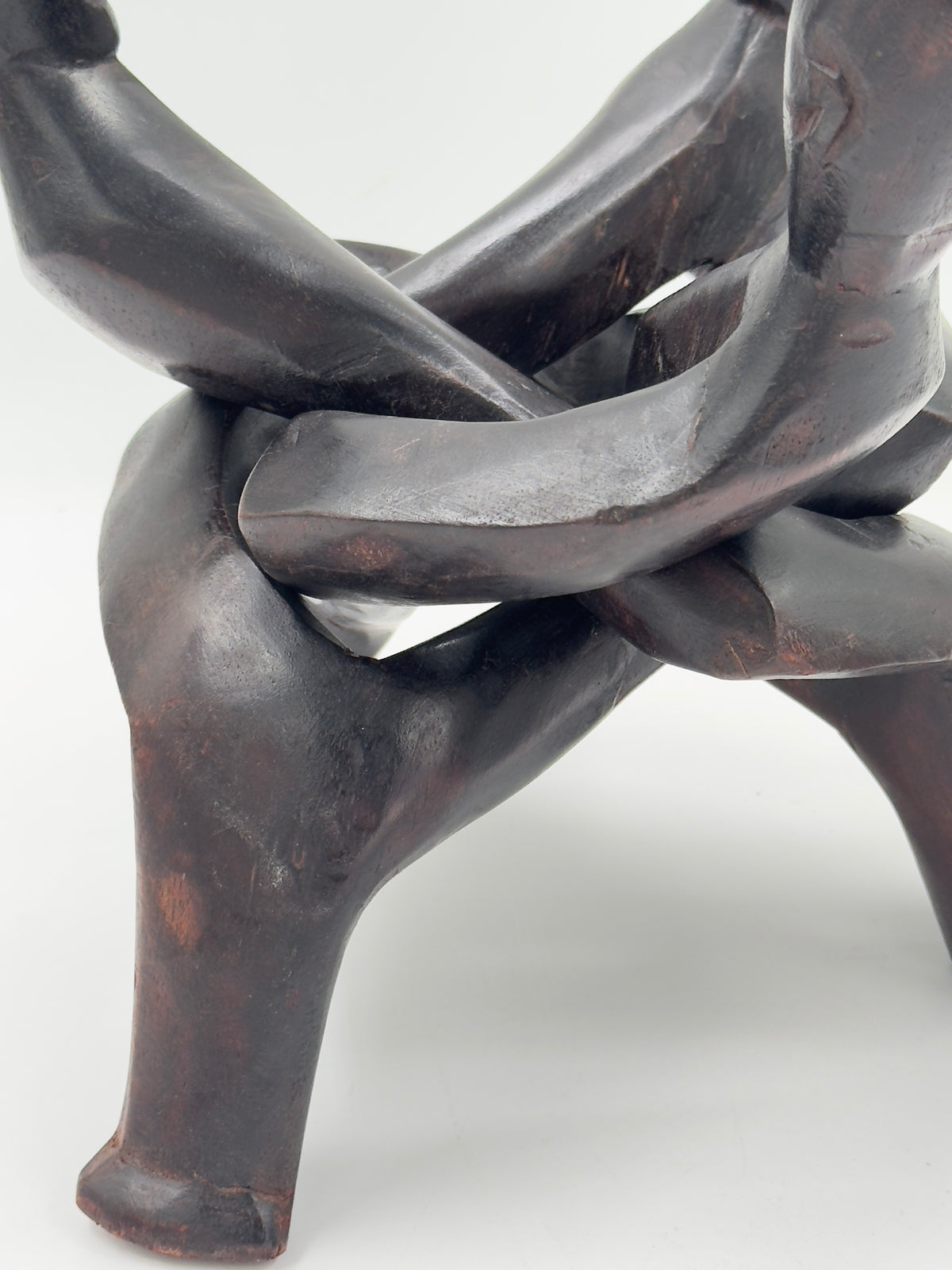 Hand-Carved Wood Sculpture of Three Interlocked Figures