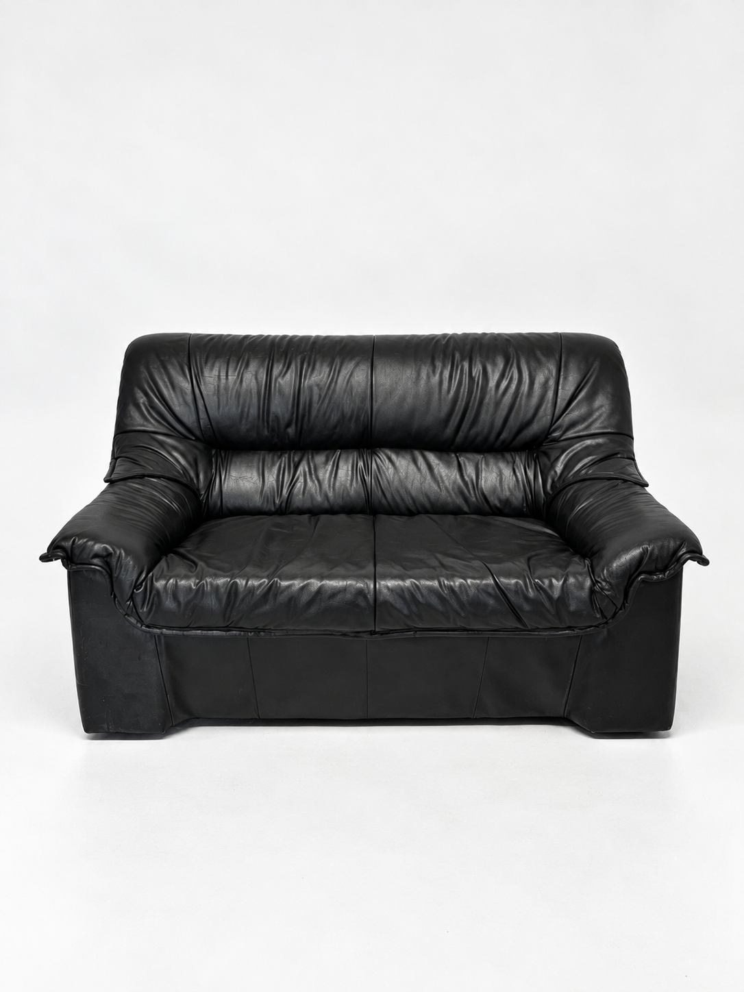 Black leather two-seater sofa, front view