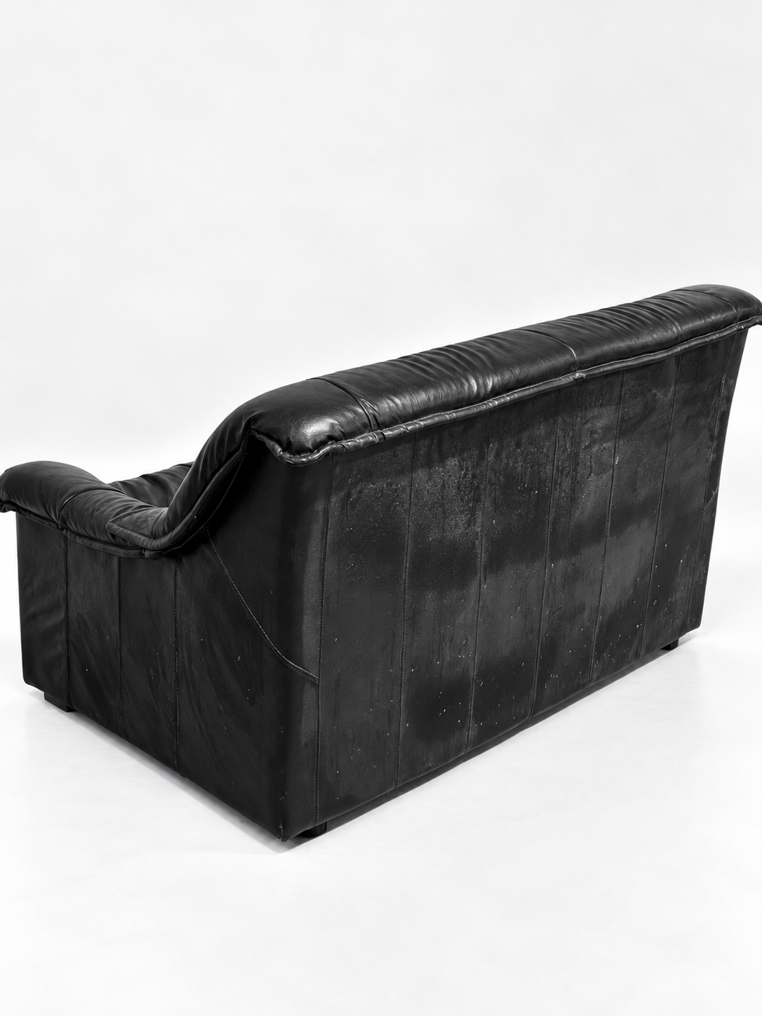 Black leather two-seater sofa, back view
