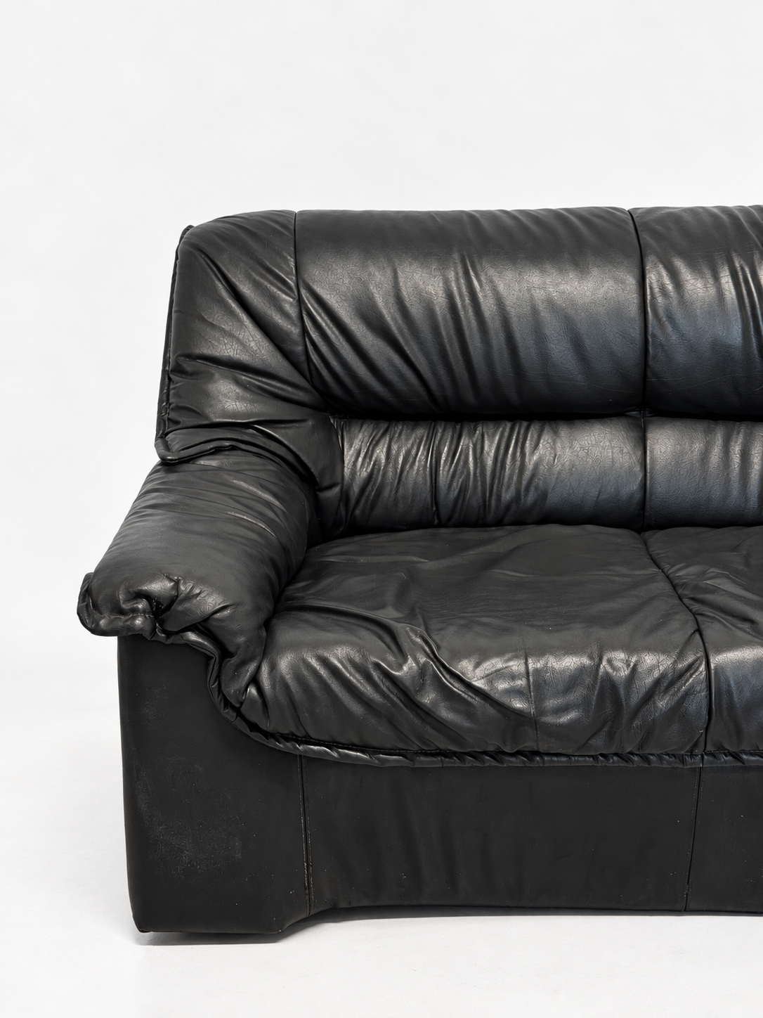 Black leather sofa, left armrest detail