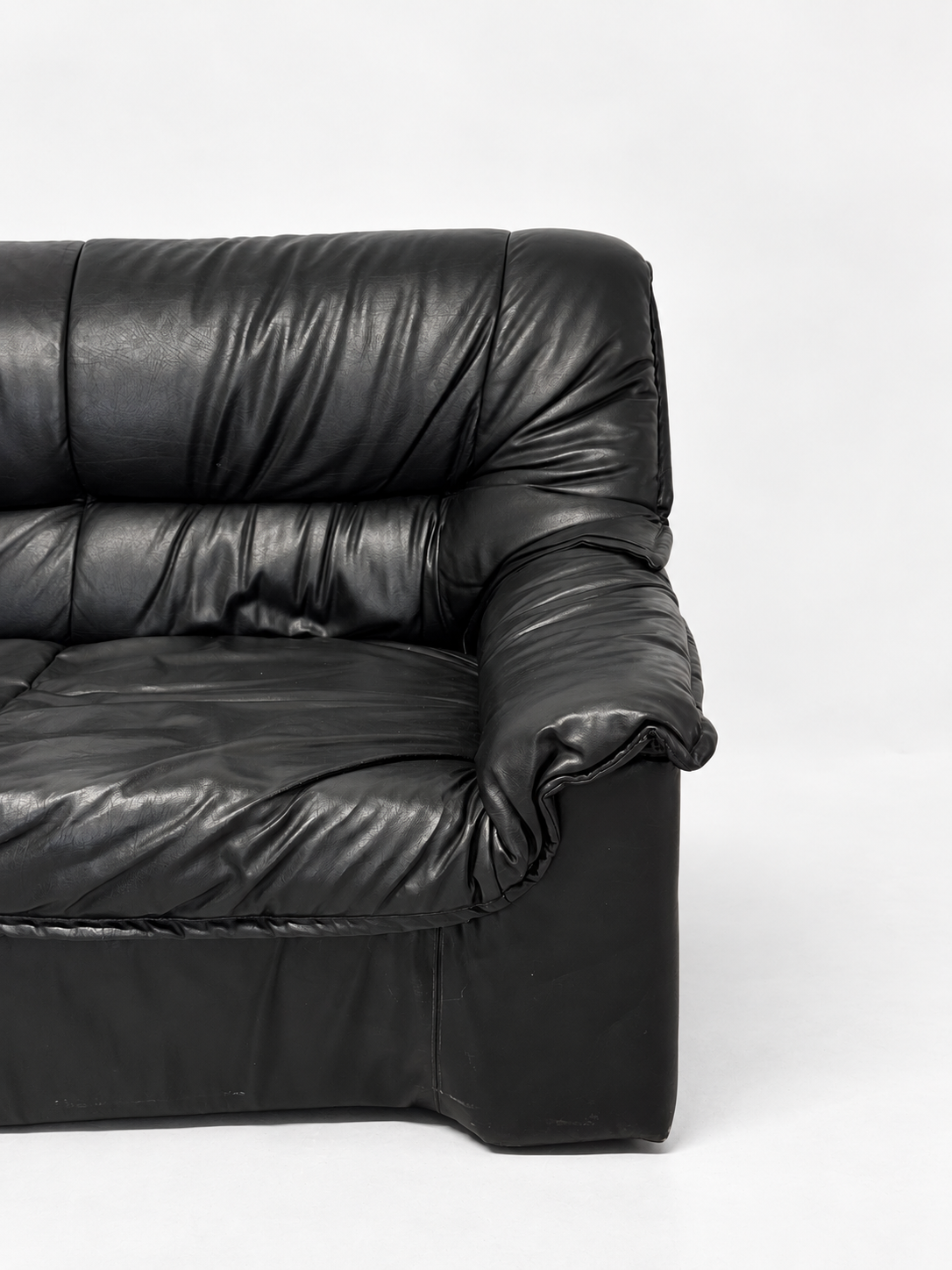 Black leather sofa, right armrest detail