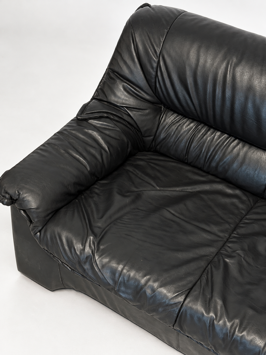 Black leather sofa, seat from above