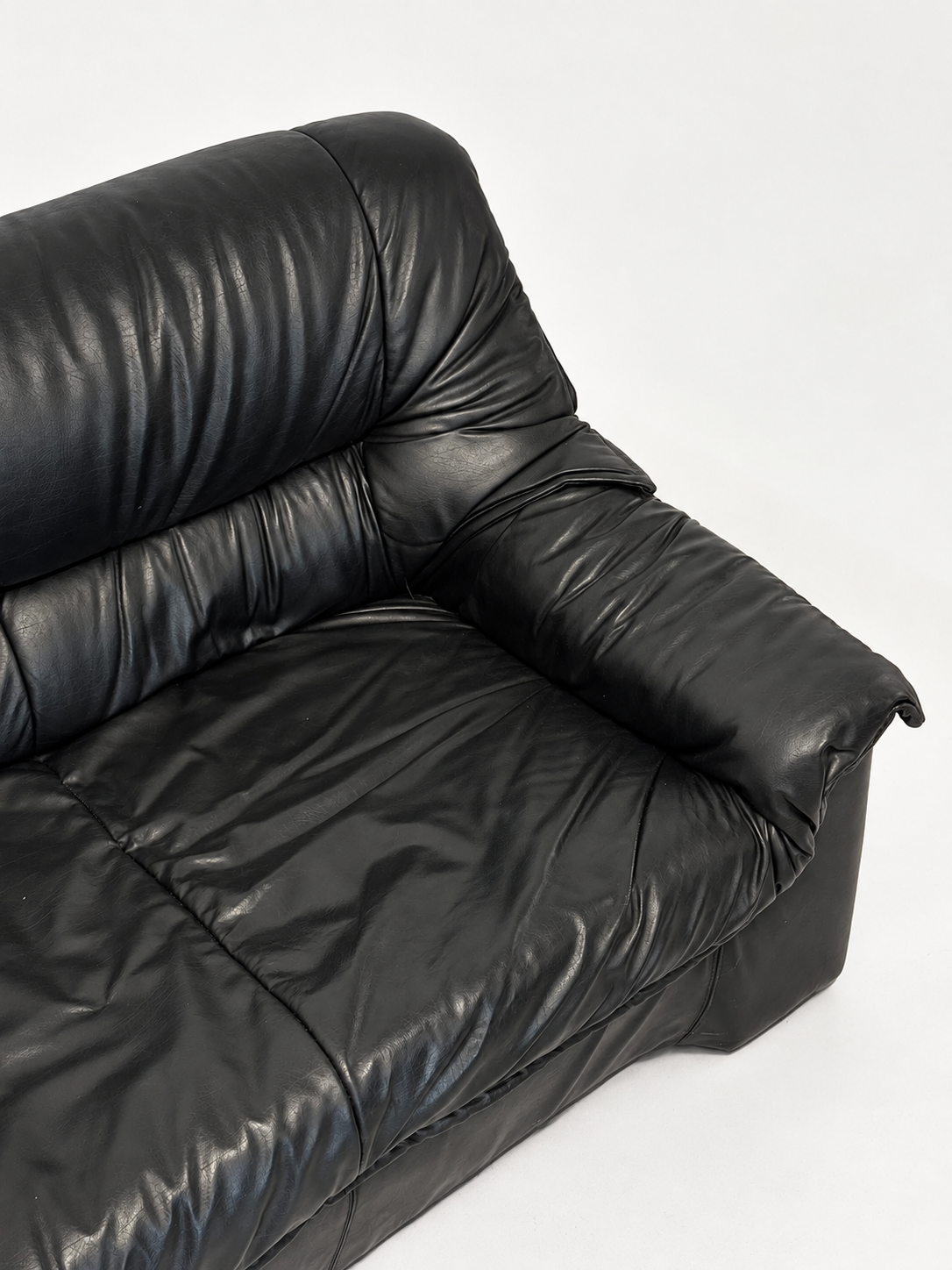 Black leather sofa, seat and armrest from above