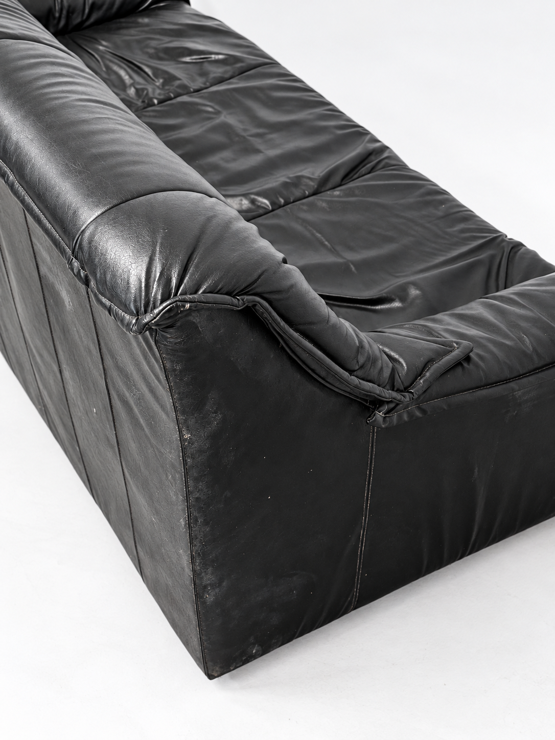 Black leather sofa, side and back corner