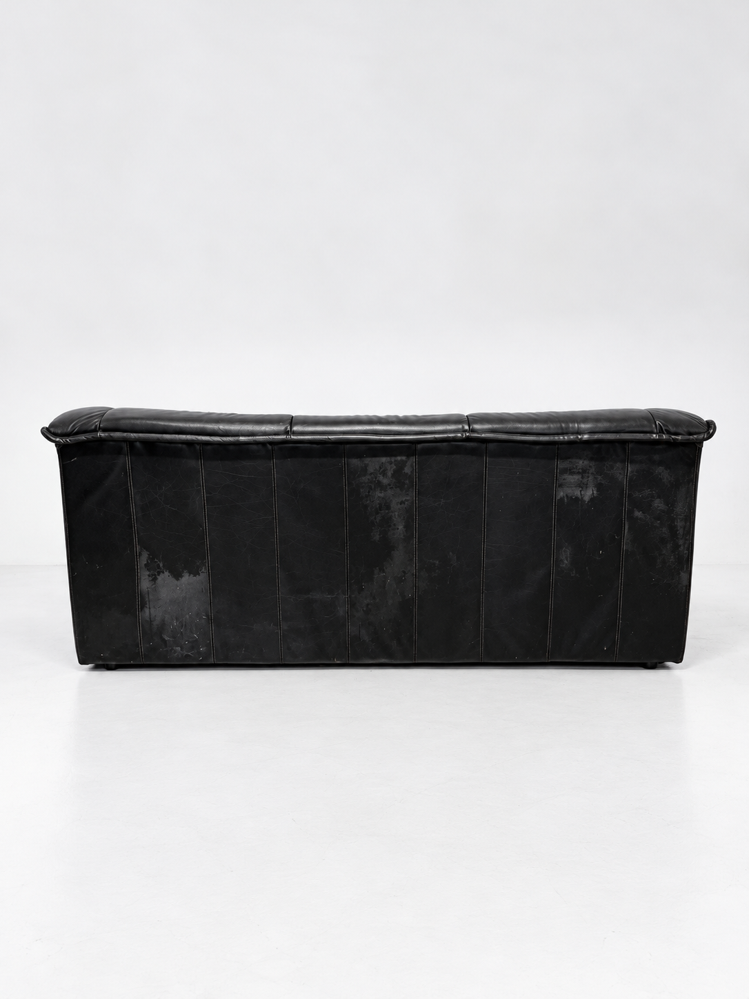 Black leather sofa, back view